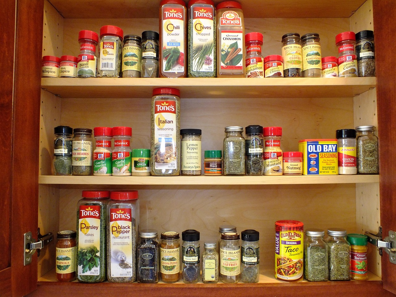 small kitchen storage ideas for indian homes with wall shelves spice jars and hanging utensils